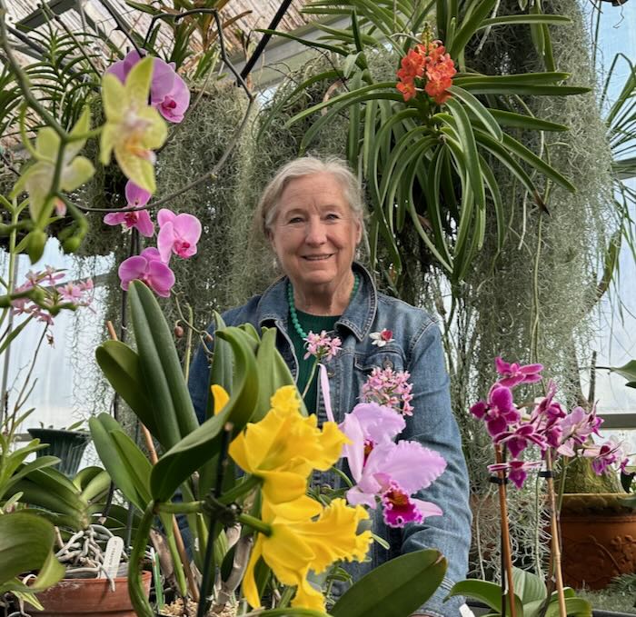 Dr. Dotty Woodson with her Orchids